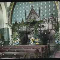 Lantern slide, color, of a church interior with floral decorations, used for promotional display in Hoboken, no date, ca. 1920.