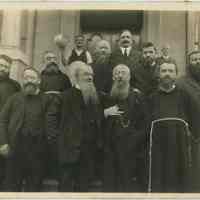 B+W group photo of 10 men, most in clerical garments on the front steps of the St. Ann