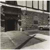 B+W photo of entrance door to Hoboken Police Department, Newark St. side of City Hall, with black bunting, Hoboken, no date, [1976].