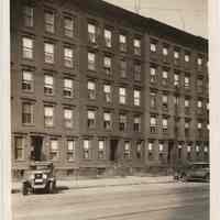 Sepia-tone photo of apartment buildings on west side of Washington St.(?) with bullet marks, Hoboken, n.d., ca. 1926-1932.