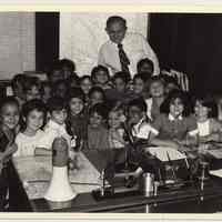 B+W photo of Mayor Tom Vezzetti with a school class in his office, City Hall, Hoboken, n.d, ca. 1985-1987.