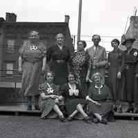 Digital image of B+W negative image of Julius Durstewitz and eight women (family?) on a roof, Hoboken. no date, circa 1938-1940.