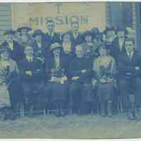 Cyanotype print of a group of men and women seated outside a church or mission building, no place [Hoboken], no date, ca. 1900-1910.