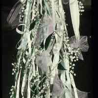 Lantern slide, color, of a floral arrangement on stand, used for promotional display in Hoboken, no date, ca. 1920.