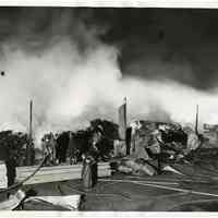 B+W photos, 2, of firemen fighting fire at lumber yard at 11th to 12 Sts. & Hudson River, Hoboken, June 17, 1937.