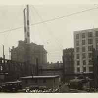 Sepia-tone photo of steel frame erection on the site for the Fabian Theatre, southeast corner of Newark & Washington Sts., Hoboken, Feb. 15, 1928.