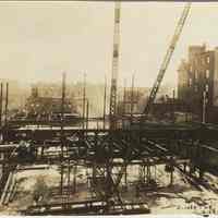 Sepia-tone photo of steel frame erection on the site for the Fabian Theatre, southeast corner of Newark & Washington Sts., Hoboken, Feb. 20, 1928.