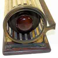          detail left end showing frame, brackets & bar for magnifier
   