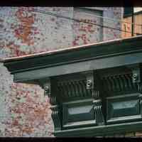 Color slide of detail view of cornice and brackets on a building on Bloomfield and 9th