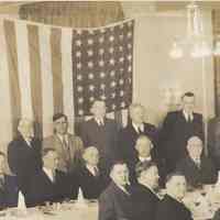          detail top left: head table: Sperber seated 3rd from left
   