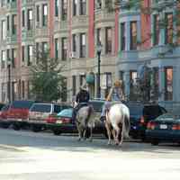 Color photo of two people riding horses on Washington St., Hoboken, September 16, 2006.