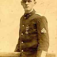 Digital image of photo postcard of George(?) Durstewitz posed Stevens Battalion Color photos uniform in photographer