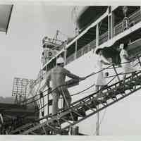 B+W photo of two nurses & Todd Shipyard engineer on gangplank of S.S. Hope, Hoboken. n.d., ca. 1960-1963.