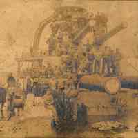 Sepia tone photo of shipyard workers posed on deck guns of unidentified naval vessel at Bath Iron Works, Bath, ME. No date, ca. 1905-1906.