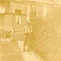 Digital image of photo of a man posed in suit with straw boater in backyard, no place, (Hoboken?), no date, circa1900 - 1930.