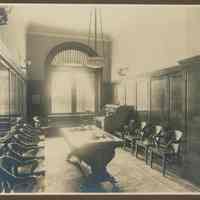 Sepia-tone photo of an office or waiting room of the Hoboken Bank for Savings, Hoboken, no date, ca. 1890.