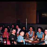 Color slide of a group of women around a table.