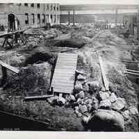 B+W photos, 2, of foundation work for new factory building at R. Neumann & Co., Ferry St. west of Willow Ave., Hoboken, July 3, 1919.