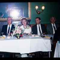 Color slide of a group of people at a table.