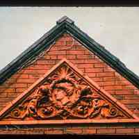 Color slide of close-up view of pediment on one of the buildings between 1210 and 1214 Bloomfield between 12th and 13th