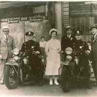 Color copy photo of a B&W photo of two motorcycle patrolmen with a nurse to the right of Rex