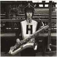 B+W photo of a male marching band member with saxophone, JFK Stadium, Hoboken, no date, [1976].