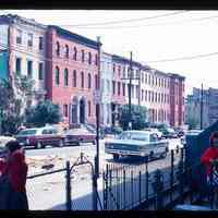 Color slide of a street and buildings with three people in the foreground.