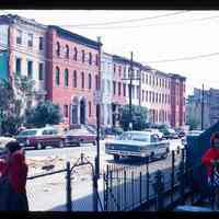 Color slide of a street and buildings with three people in the foreground.