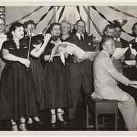 B+W group photo of choir with violin & piano at the Hoboken YMCA, Hoboken, n.d., ca. 1950-1955.