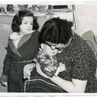 B+W photo of Anna Scutellaro, wife of Joseph Scutellaro, with children, Marie & Joseph, Jr., in apartment kitchen, 611 Monroe St., Hoboken, N.J., Feb. 25, 1938.