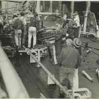 B+W photo showing workers repairing damage on the main deck on unidentified vessel at the Bethlehem Steel Shipyard, Hoboken Division, no date, ca. 194