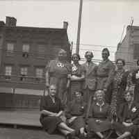 Digital image of B+W negative image of Anthony Durstewitz (Senior) and eight women (family?) on a roof, Hoboken. no date, circa 1938-1940.