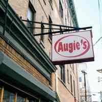 Color photo of hanging sign for Augie