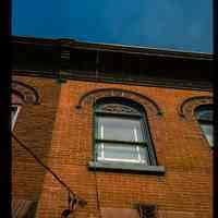          Color slide of detail view of façade, keystone, flat arch, semicircular arch and cornice of one of the buildings between 206 and 218 13th on the N side between Park and Garden. picture number 1
   