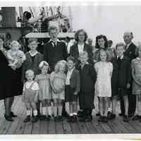 B+W photo of Jacobus & Tjitske Hut & their 13 children posed on S.S. Veendam at arrival in Hoboken from Holland, July 22, 1947.