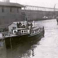 Sepia-tone photo of ferry & floating boat club houses at 4th St. & Hudson River Hoboken, n.d., ca. 1920s.