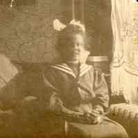 Digital image of sepia-tone photo of Leonore Toepfer circa 10 years of age in a sailor suit posed in a room, no place (Hoboken?), no date, circa 1900.