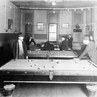 Sepia-tone group photo of men playing billiards or pool at the Hoboken YMCA, Hoboken, no date, ca. 1918-21.