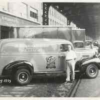 B+W photo of R. Neumann & Co. driver with trucks outside building on Ferry St., Hoboken, August 7, 1939.