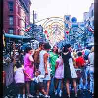 Color slide of a group of people at a street fair/festival.