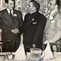 Digital image of b+w photo of Mayor Fred DeSapio shaking hand of Father Salvatore Federico at his testimonial dinner, Union City, July 24, 1952.