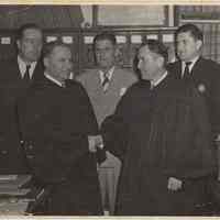 B+W photo of two judges in a handshake with three men looking on, Hoboken, no date, circa 1945-1950.