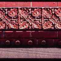 Color slide of close up-view of decorative tile on one of the buildings between 725 and 731 Washington between 7th and 8th