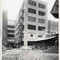 B+W photo of window glass installation; exterior fire stairs on new factory building at R. Neumann & Co., Hoboken, Nov. 1, 1919.