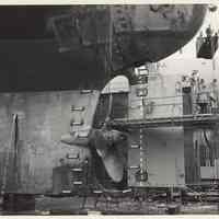 B+W photo of MV Grand Justice with repaired rudder & prop in dry dock at Bethlehem Steel Shipyard, Hoboken, n.d., April-May 1975.