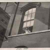 Digital image of B+W photo of Paul Millenthal leaning out a second story window, Stevens Hoboken Academy, Hoboken, February, 1955.