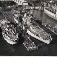 B+W aerial photo of S.S. Ezra Sensibar & U.S.S. Compass Island at Bethlehem Steel Hoboken Shipyard, n.d., ca. 1969.