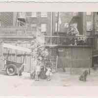 Digital image of b+w photo of Lucille Conti (left) & unknown girl in a backyard near Yum Yum cart at 416 Clinton St., Hoboken, n.d., ca. 1950s.