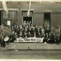 B+W group photo of men posed outside U.S. army enlistment center, West Hoboken, n.d., ca. June 1918.