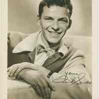 Sepia-tone textured photo of a young Frank Sinatra seated in a lounging jacket & bowtie; inscribed, signed in image, no place, no date, ca. 1939-1943.